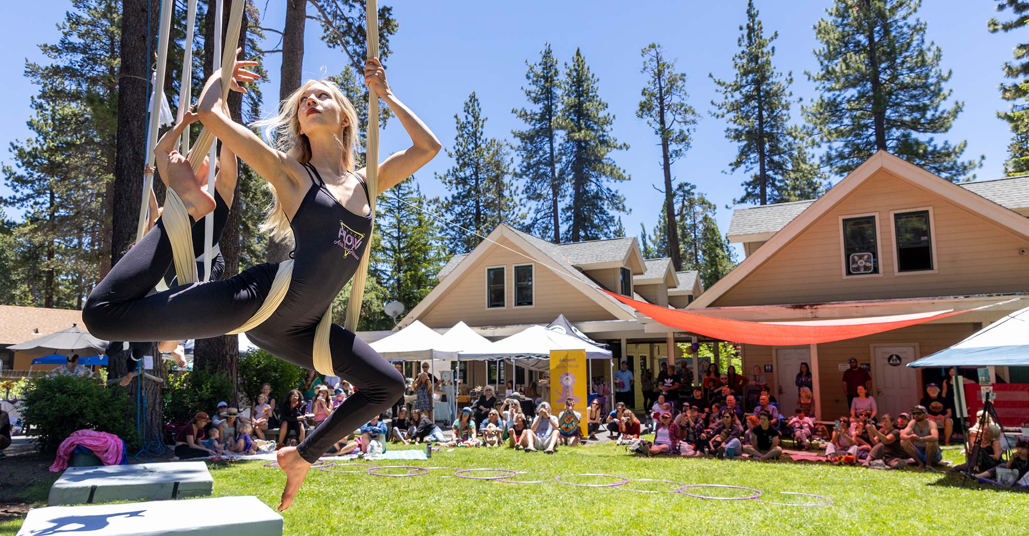 aerialist hangs on silks